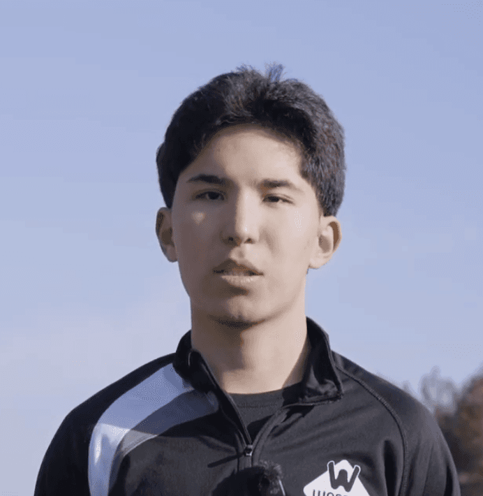man standing near white wall