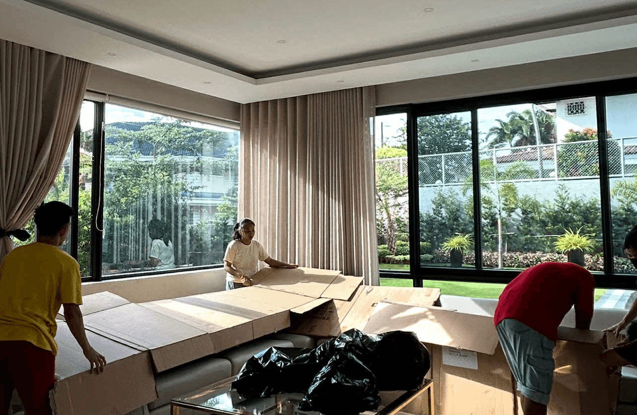 person in blue long sleeve shirt sitting beside black laptop computer