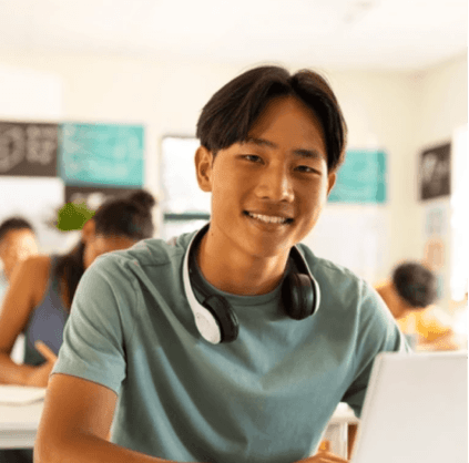 Boy studying on his computer and smiling