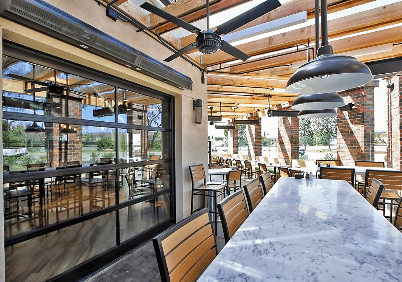 Exterior patio with tables, designed for outdoor dining and comfort.