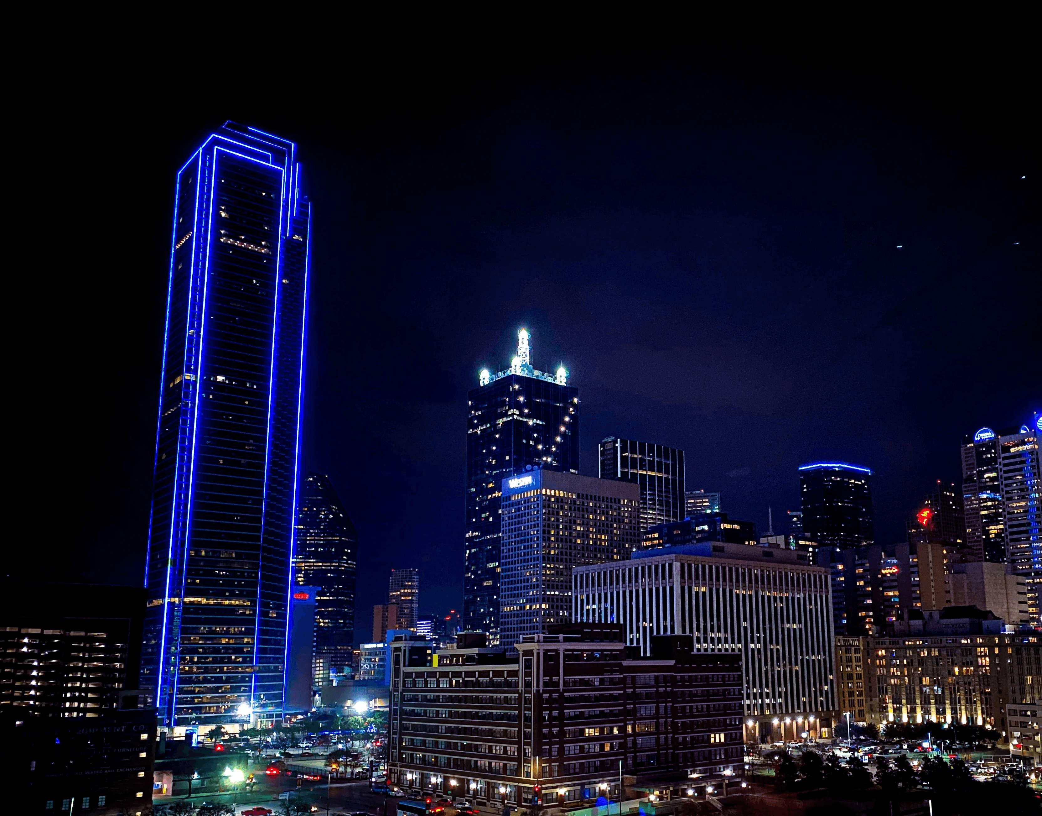 aerial photography of city with high-rise buildings during night time