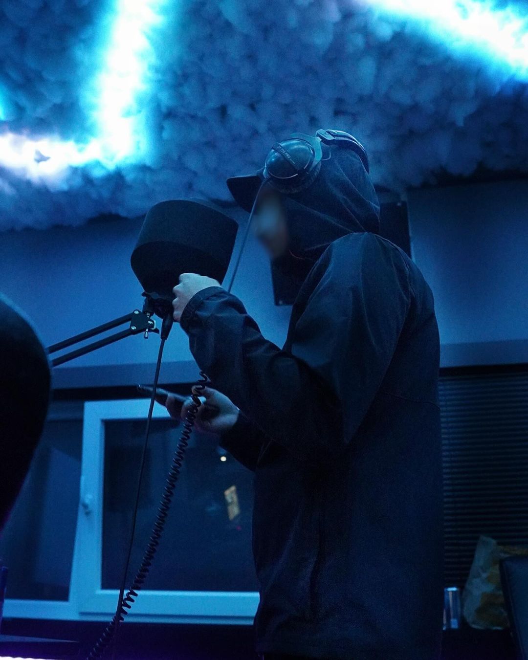 Silhouette of a woman against a dark brown silk background