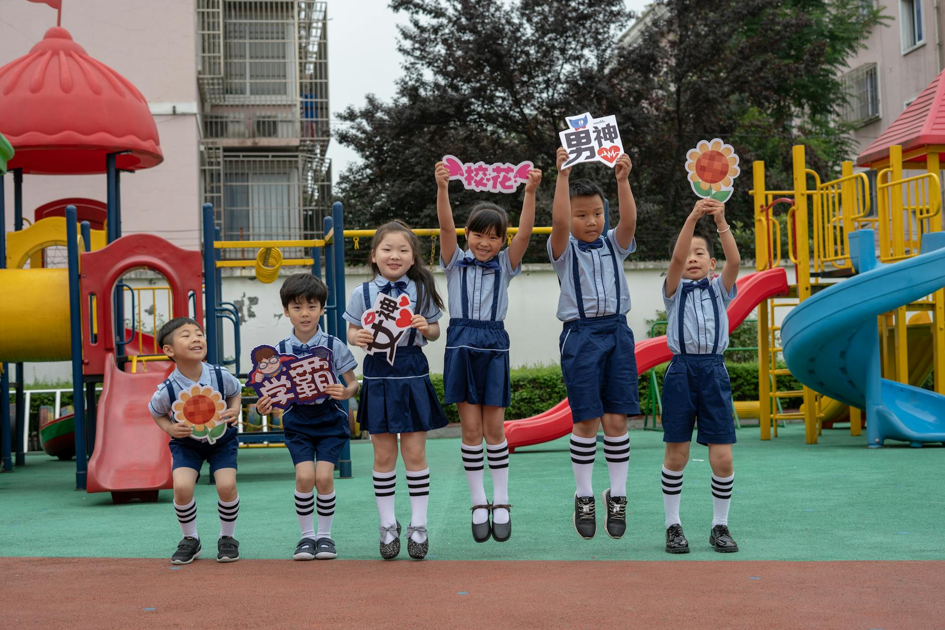 Elementary students jumping and doing high-knees during active movement breaks in the classroom to release energy.