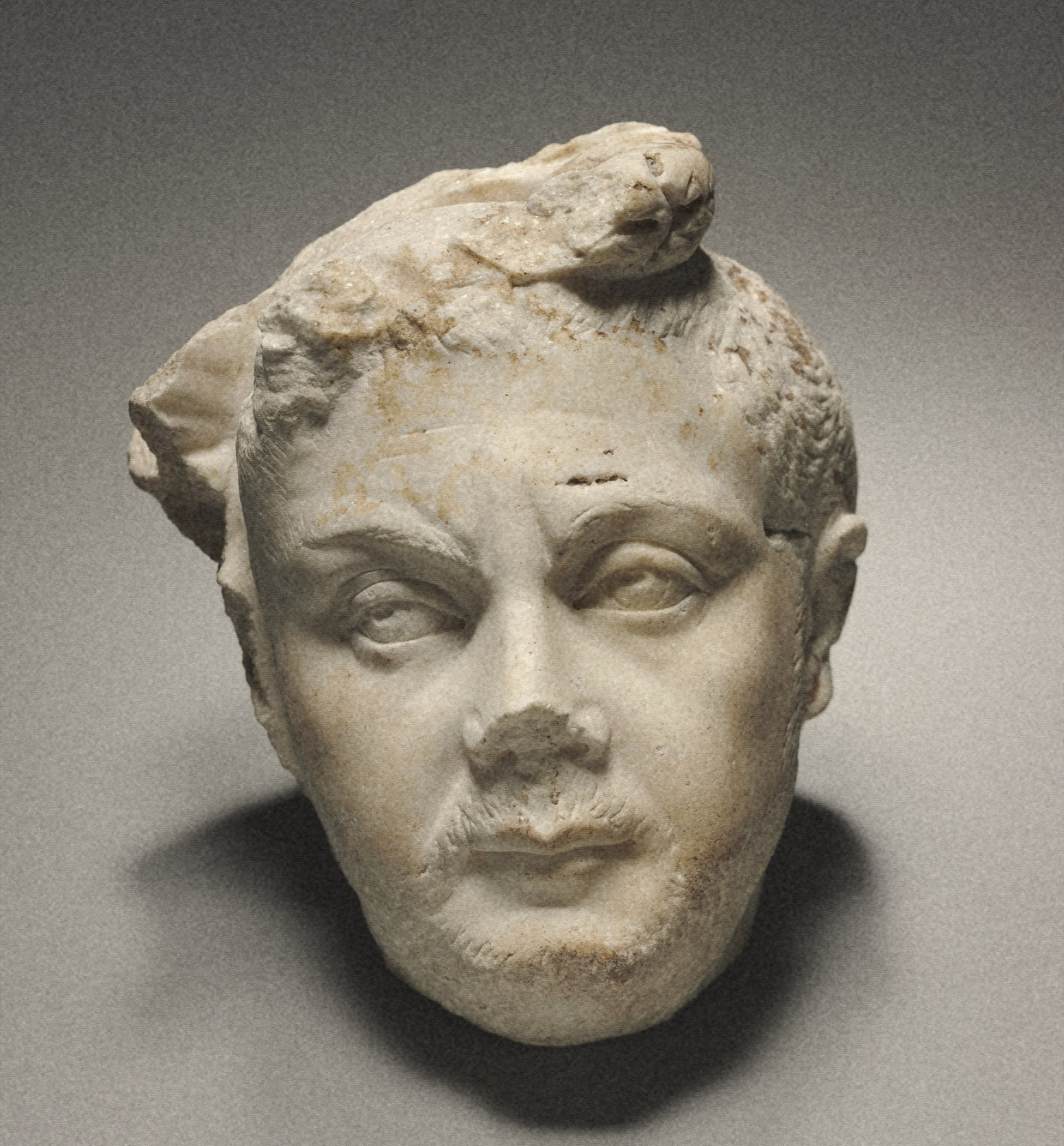 relief portrait head of a bearded man, broken crown