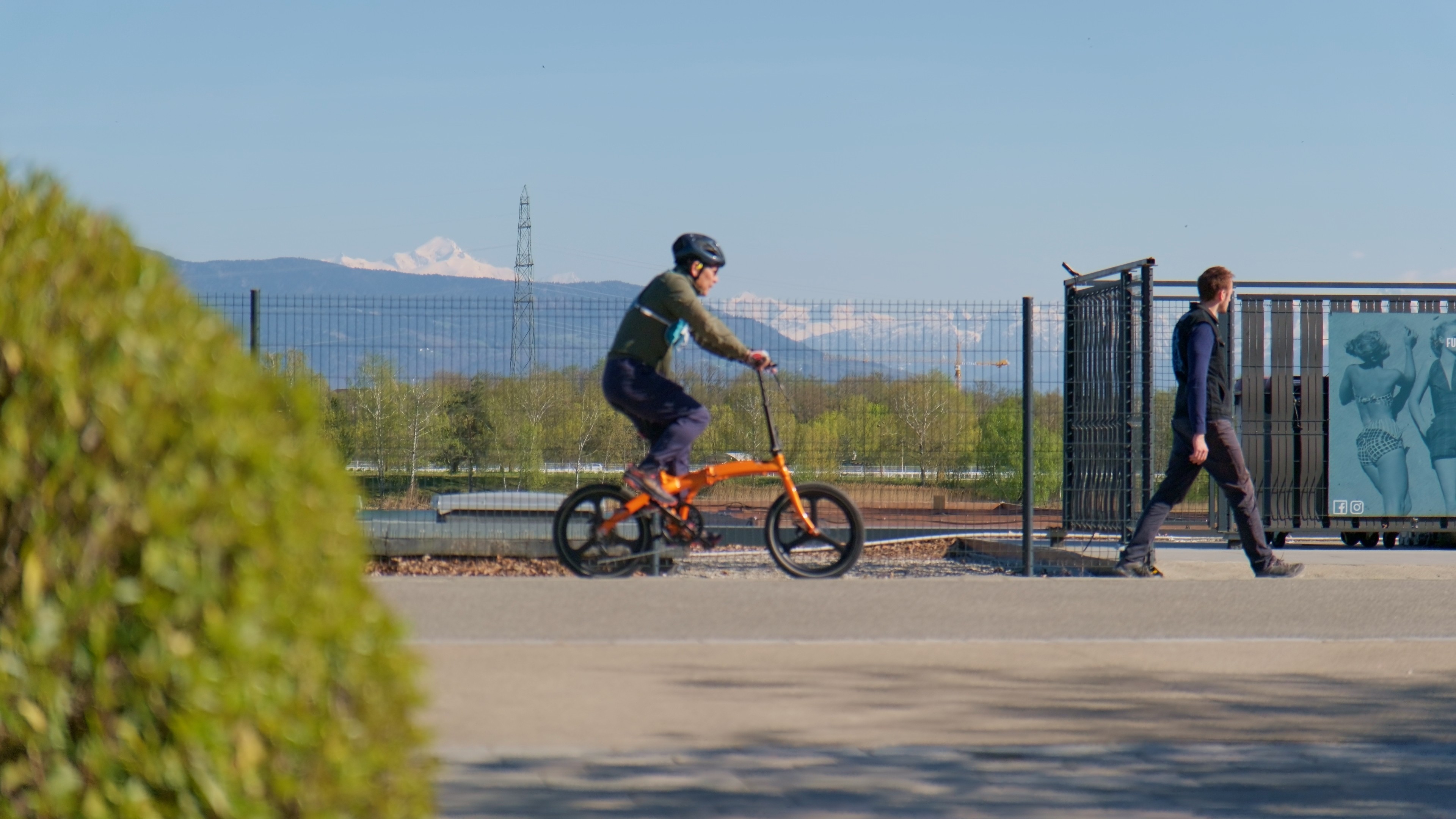 Modern living room with red sofa and grey chairs.