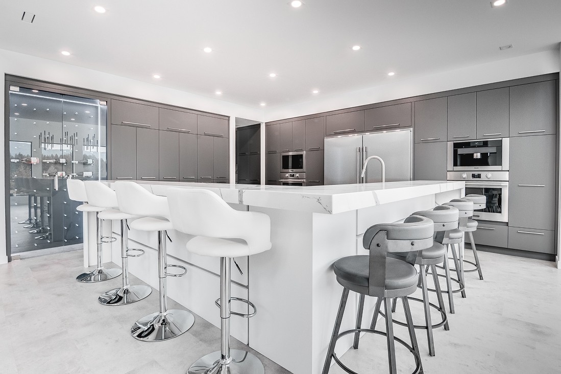 Wide view of kitchen with pendant lights and dining space