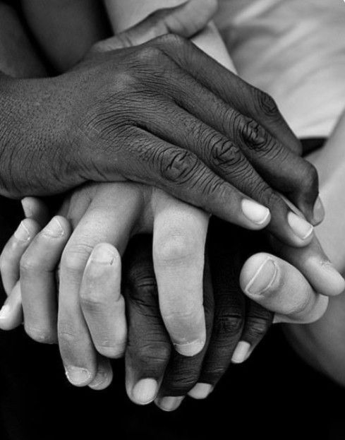 Two businessmen shaking hands across a desk with documents and a pen, symbolizing a successful business agreement.