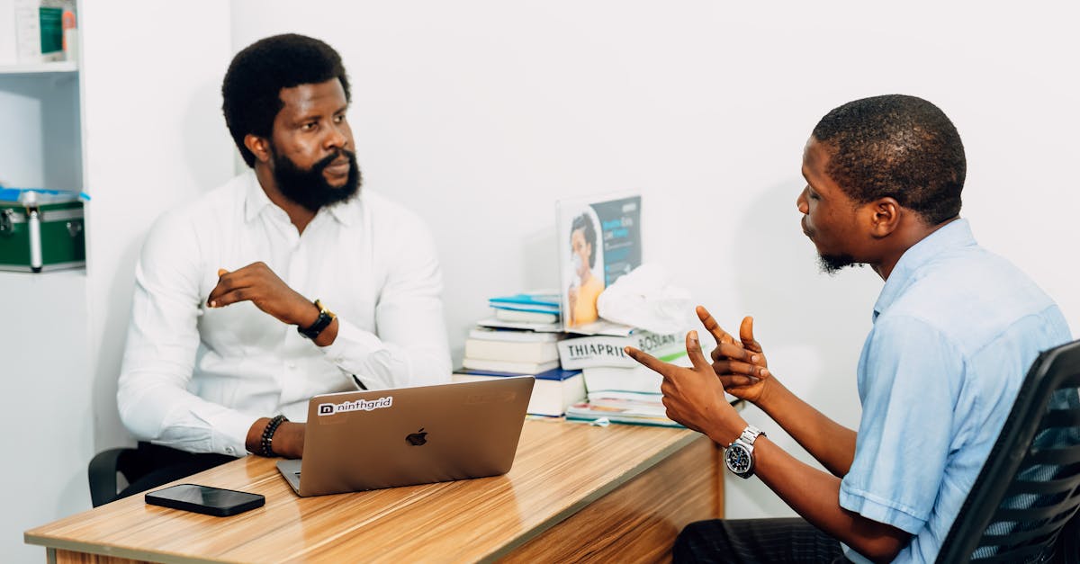 Two adults engaged in a professional consultation in a Lagos office, discussing business or healthca
