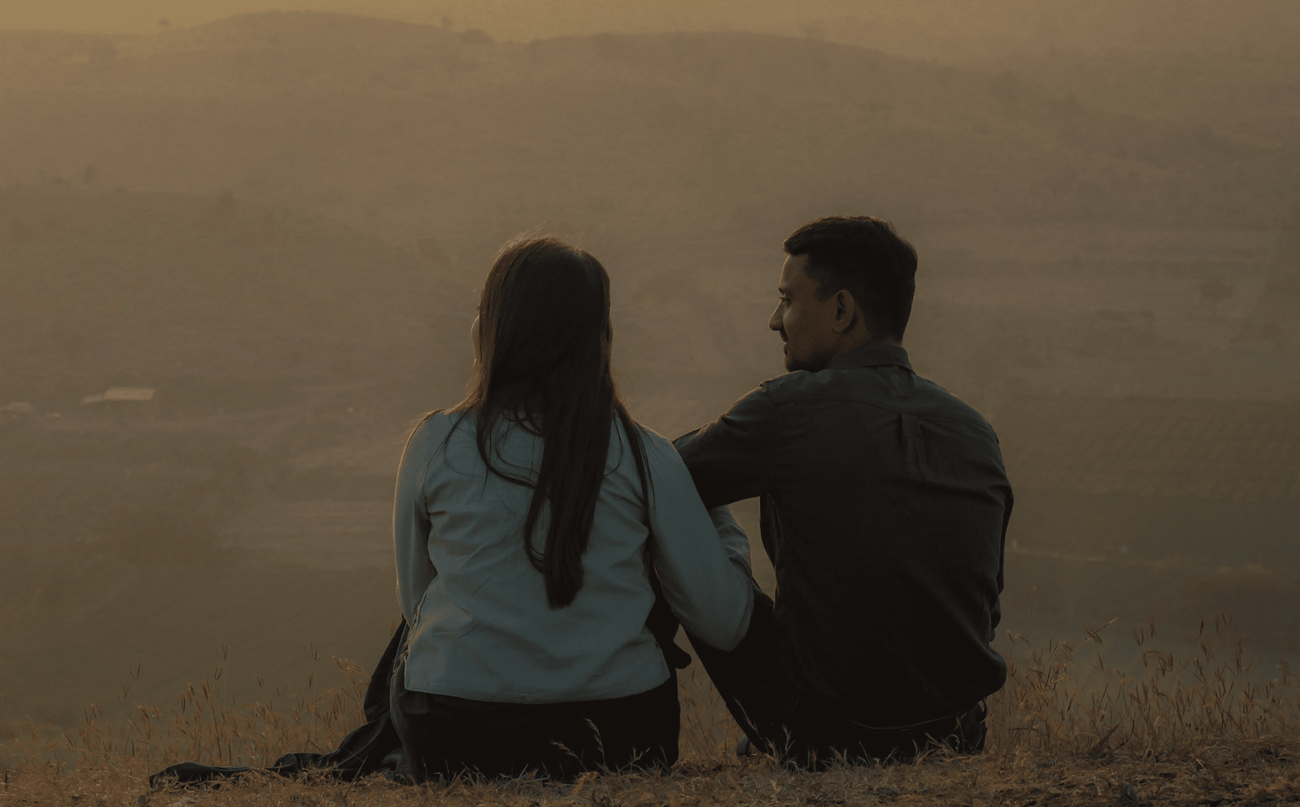 Woman relaxing in gray crop top on woven mat