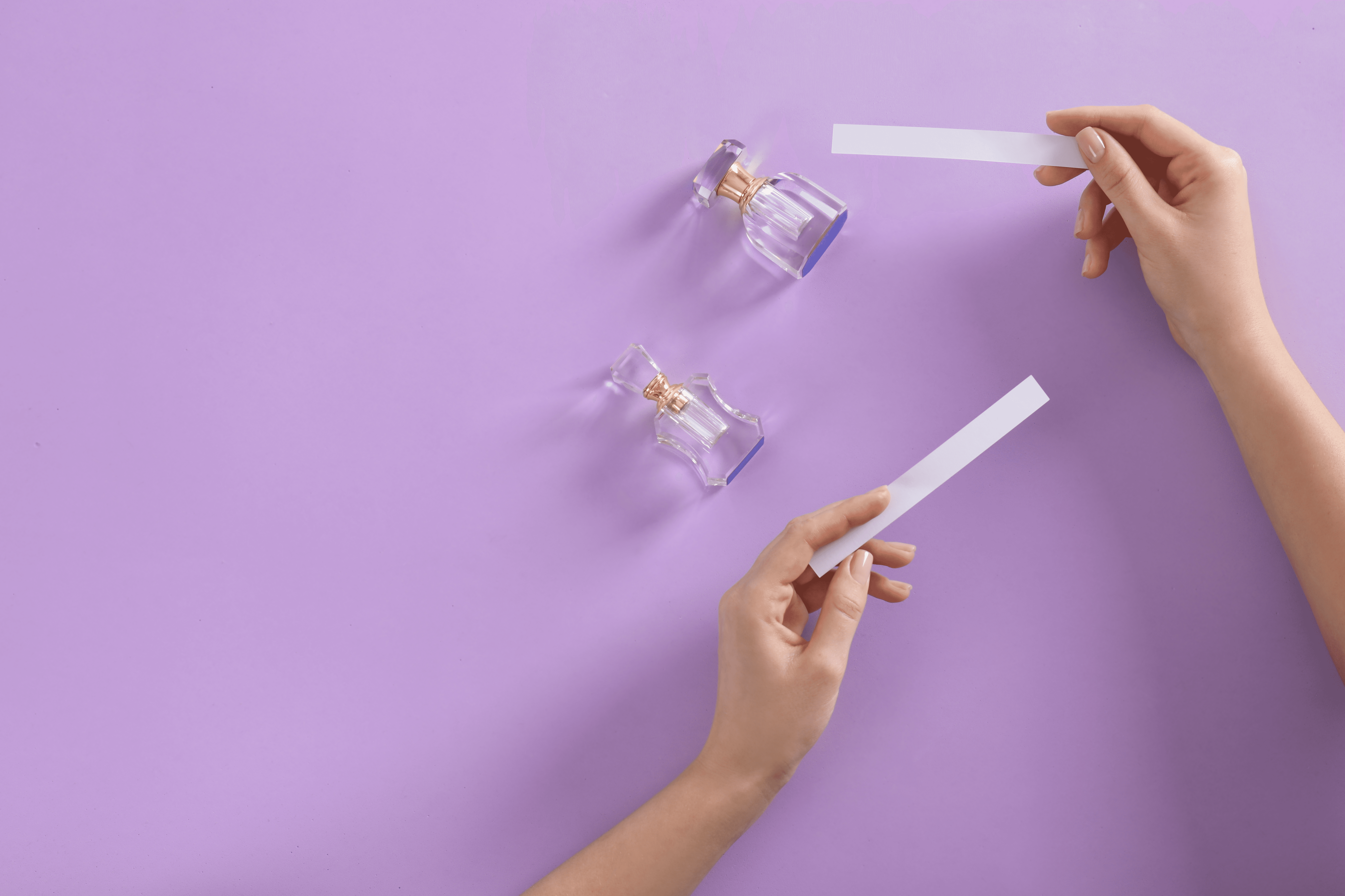 Fragrance Testing using Strips in a lavender background