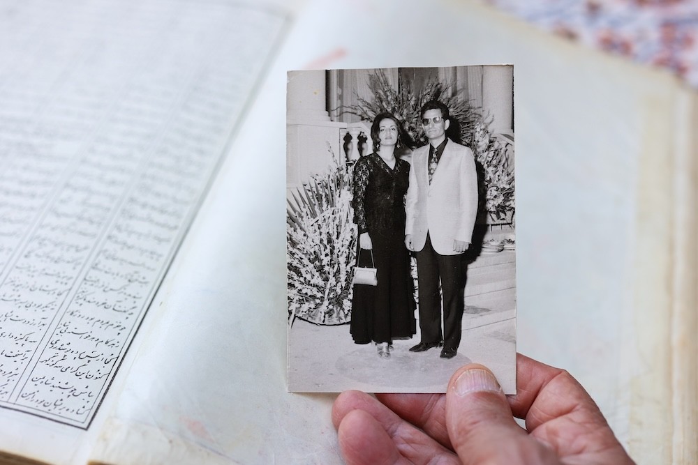 Bubjan with book and speaking to camera