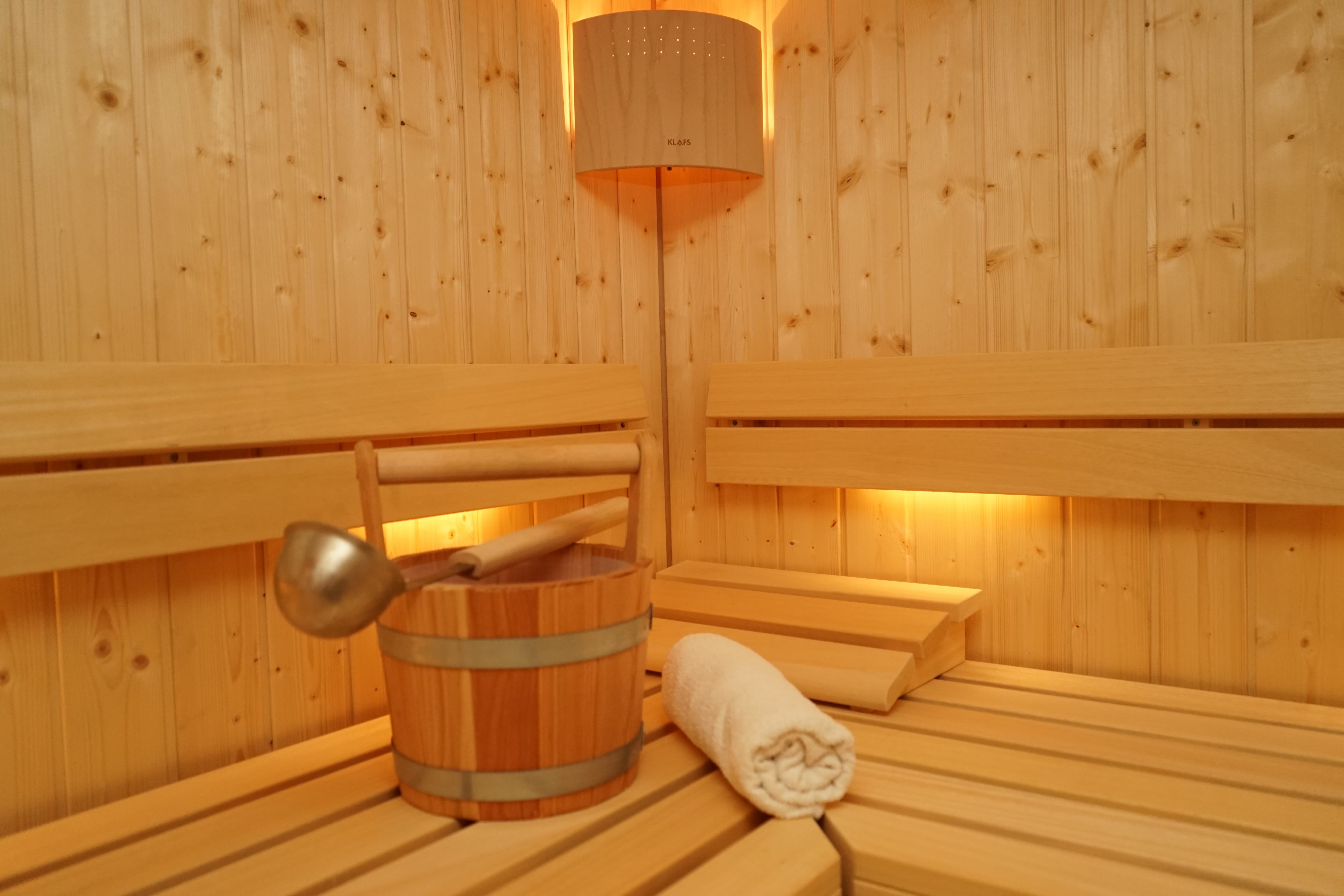 Finnish sauna with pouring bucket and towel