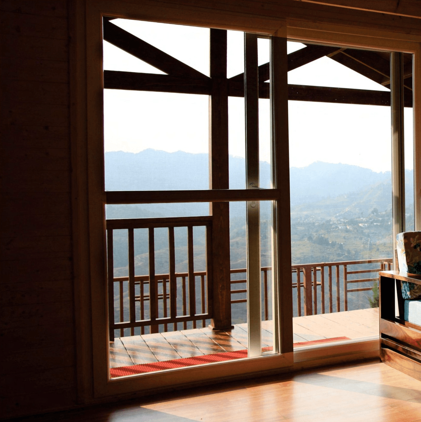 <img src="balcony-mountains.jpg" alt="Balcony overlooking a dramatic mountain range covered in clouds.">