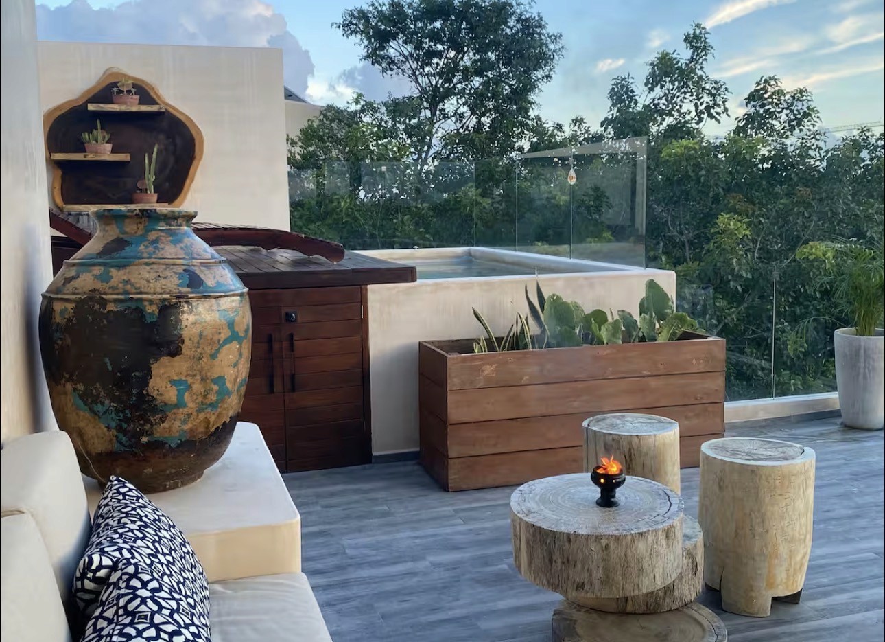 A beautiful young woman smiling at the camera on a mountain field