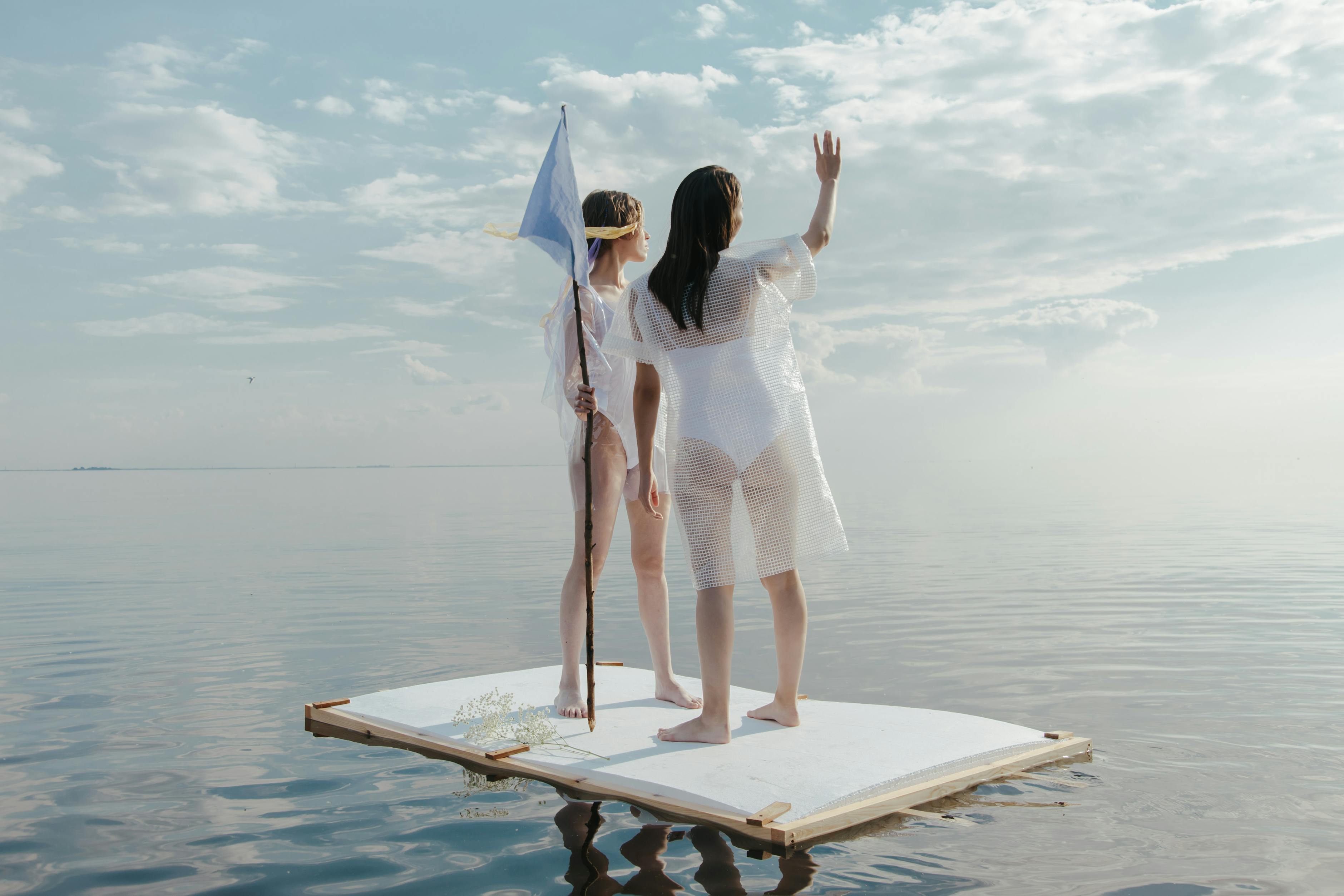 Women side by side looking at the horizon on a wooden platform