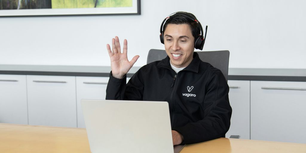 a man wearing headphones sitting in front of a laptop computer