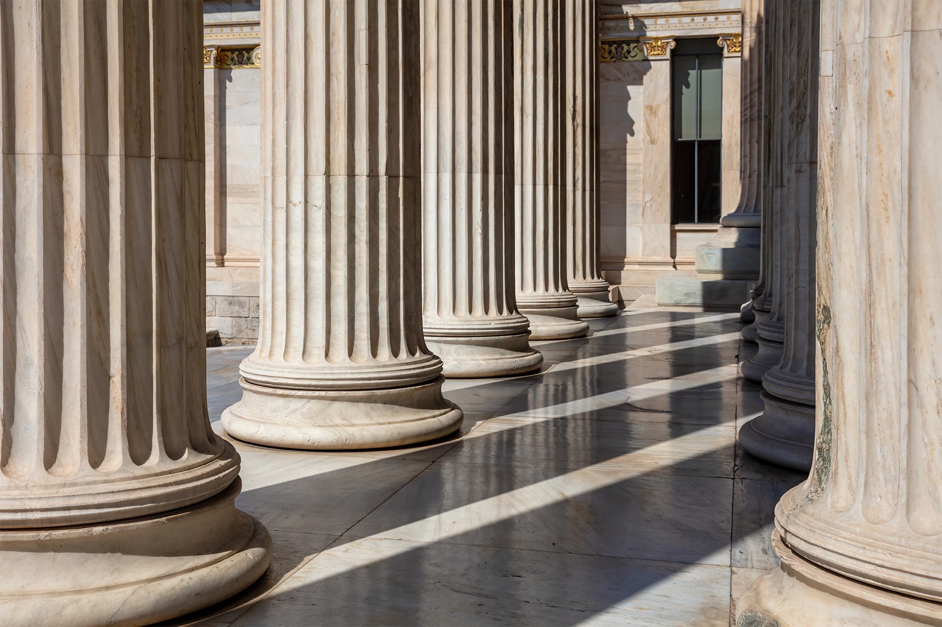 Close-up of courthouse columns representing the legal process for sexual harassment claims and justice