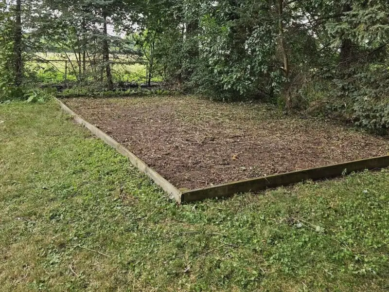 After: cleared, tidy framed garden bed