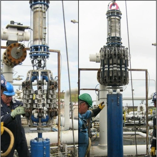 Two workers next to oilfield equipment during assembly. Blue pipes and metal construction.