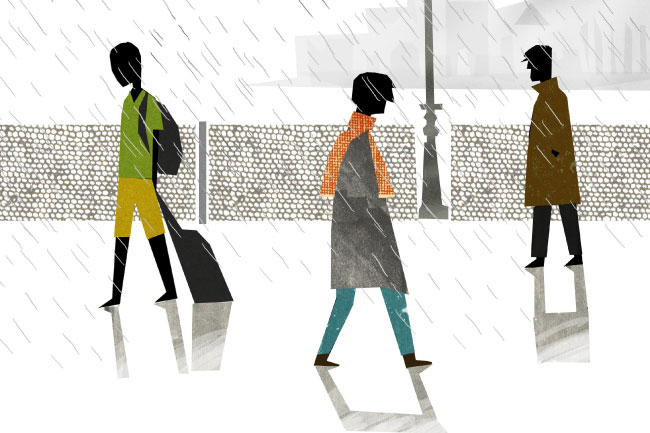Three stylized figures walk across a rain-streaked street. The leftmost figure wears a green shirt and yellow shorts, carrying a dark bag. The middle figure wears a gray coat with an orange scarf and blue pants. The rightmost figure wears a brown coat and dark pants. All figures have dark silhouettes and are depicted with simple geometric shapes and solid colors. The street is wet, with white lines suggesting rain falling. A gray fence runs along the left side of the street, and a gray pole stands near the fence.