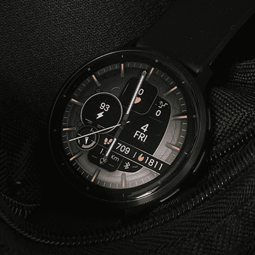 Modern garmin smartwatch displaying an analog bronze watch face
