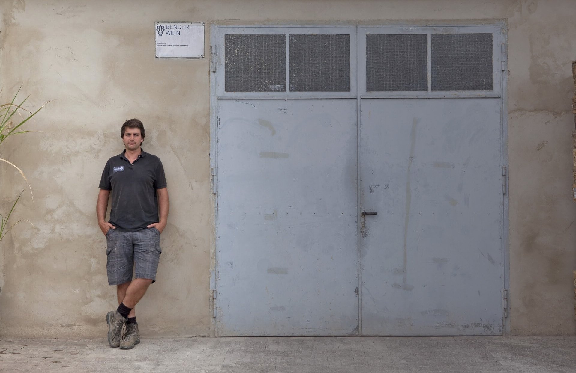 Stacks of cardboard boxes printed with black logos fill the frame, forming a repeating pattern.