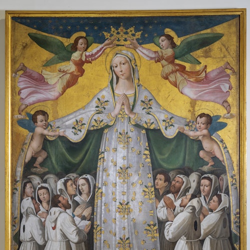 A painting depicts the Virgin Mary in a white robe with gold details, being crowned by two angels, surrounded by praying figures.