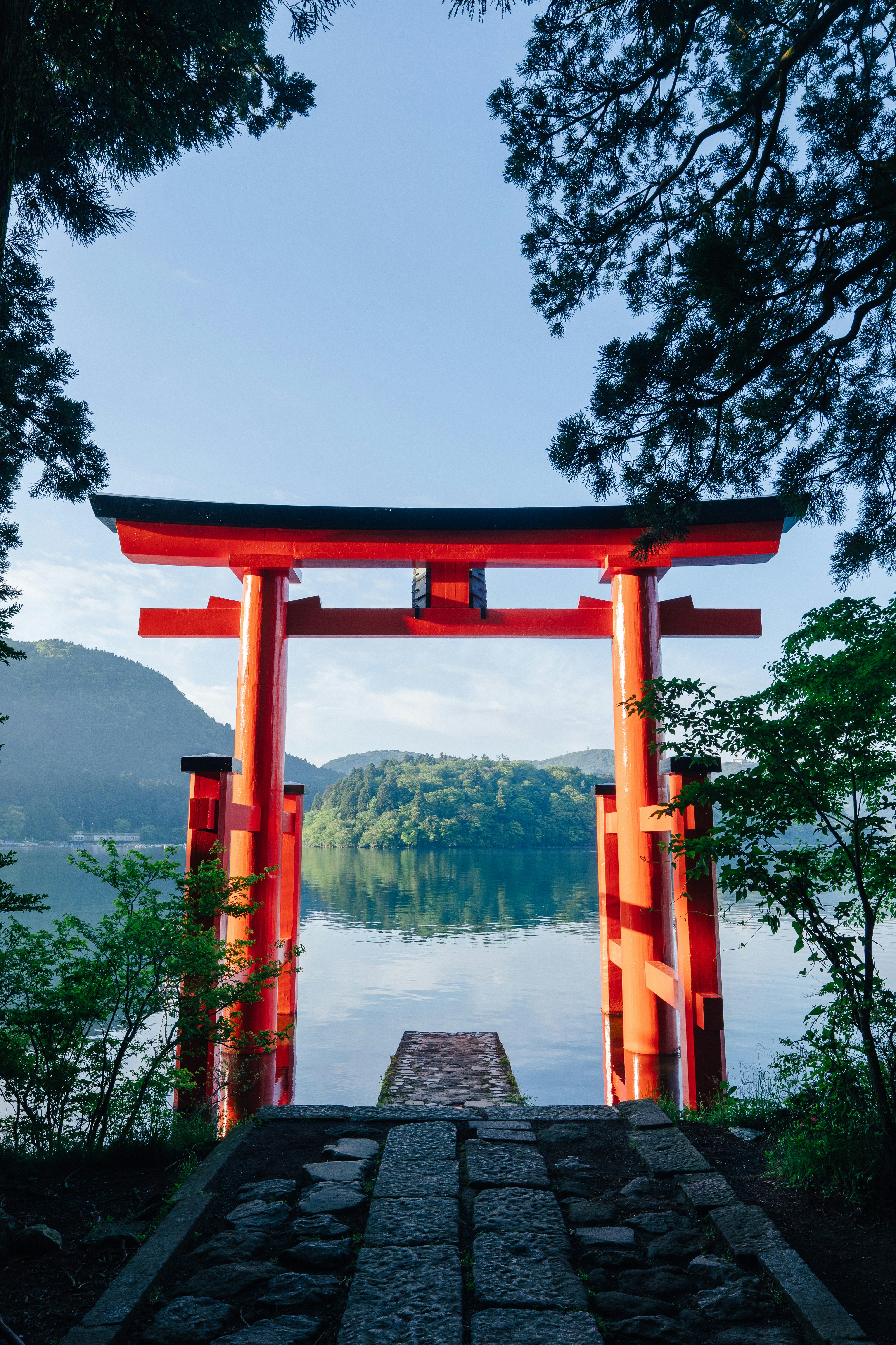 red wooden arch near lake during daytime