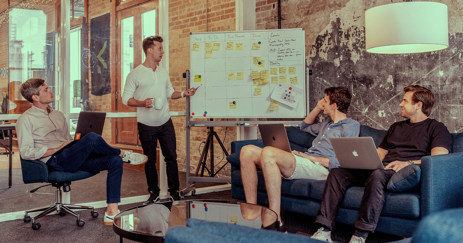 Office collegues meeting around a whiteboard