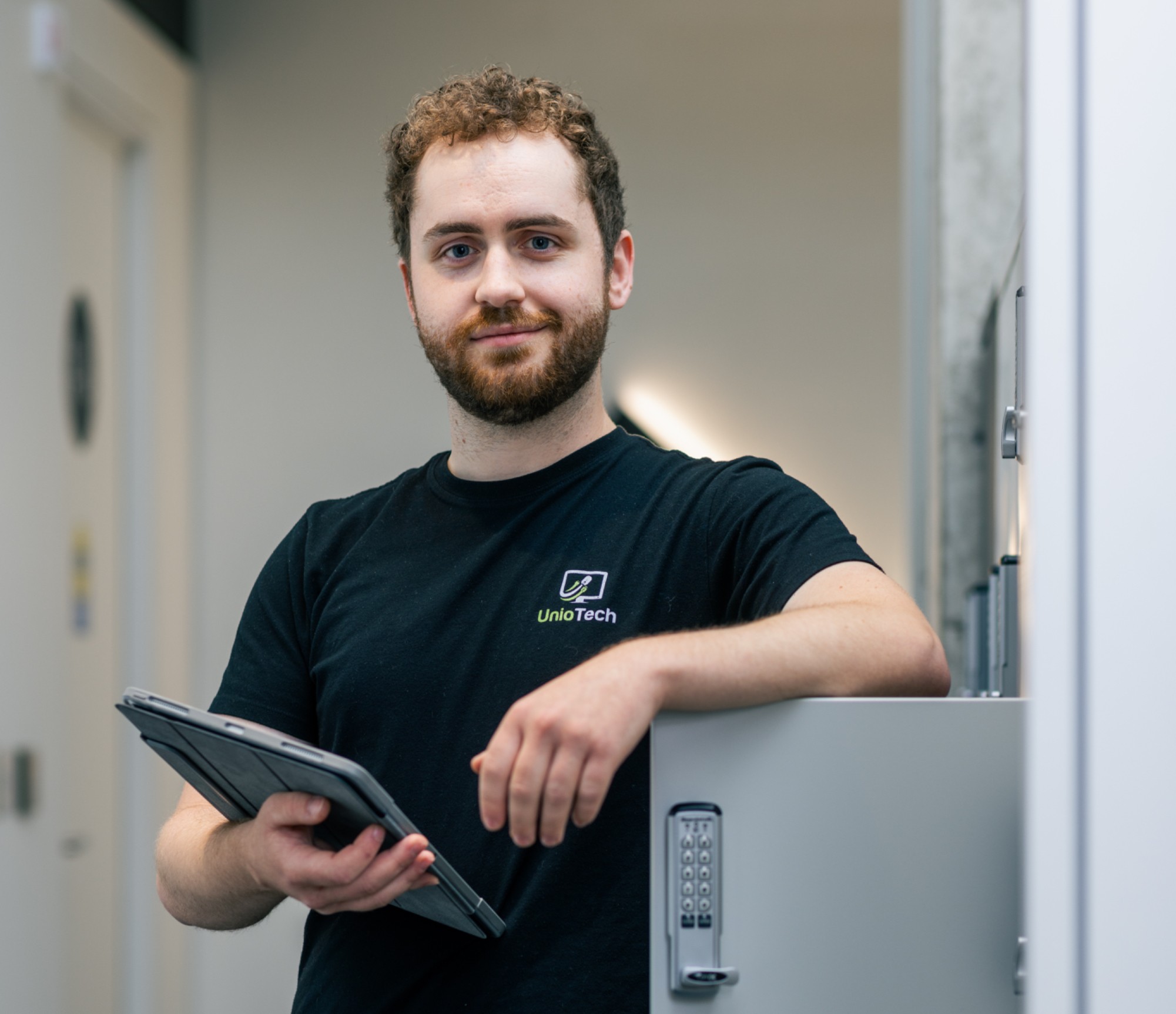 Organized server rack with structured network cabling, featuring labeled patch panels, blue Ethernet cables, and clean cable management in a data center environment