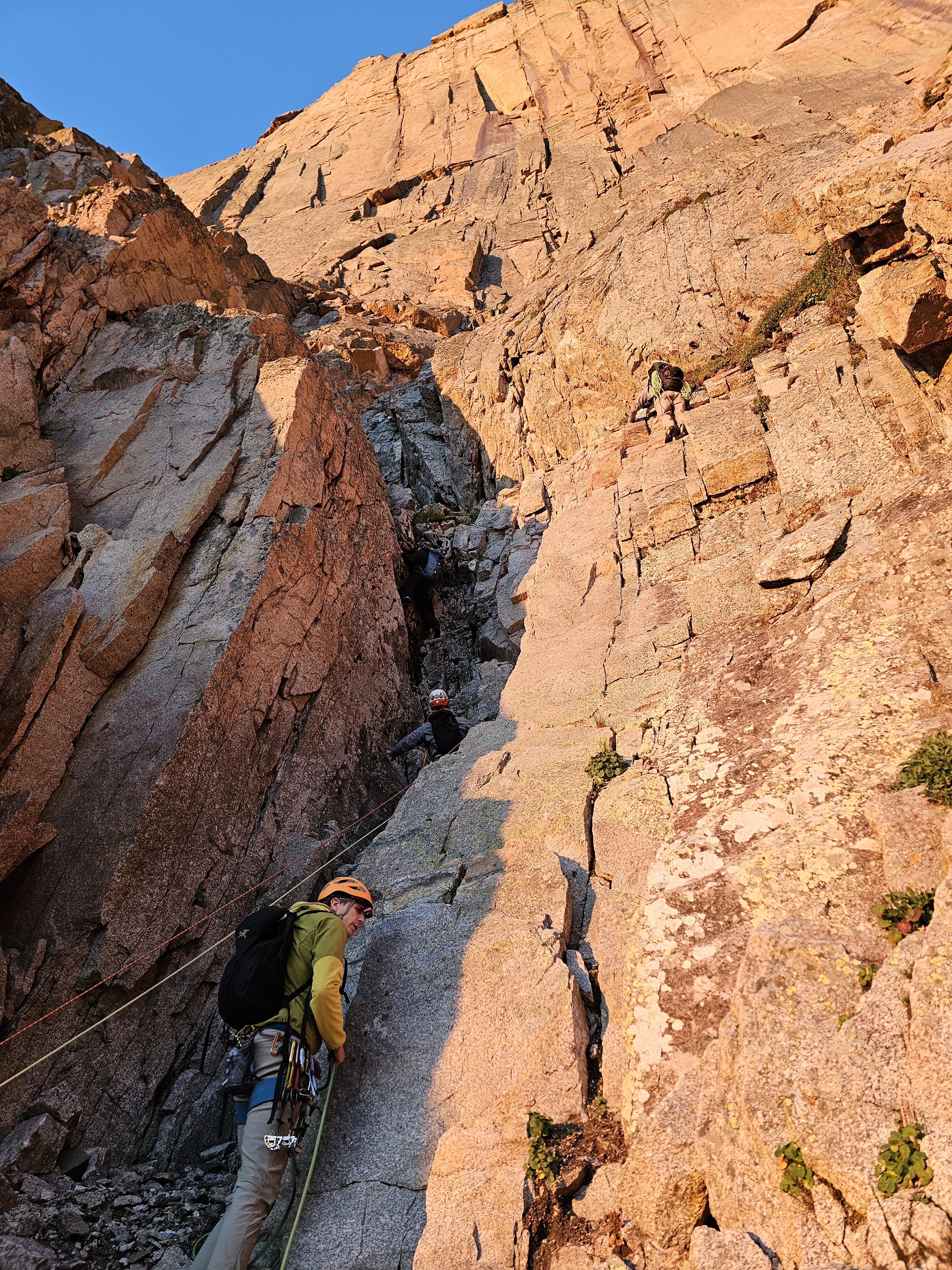 A client waits in the shadow as another party slides by in the North Chimney with The Diamond looming above