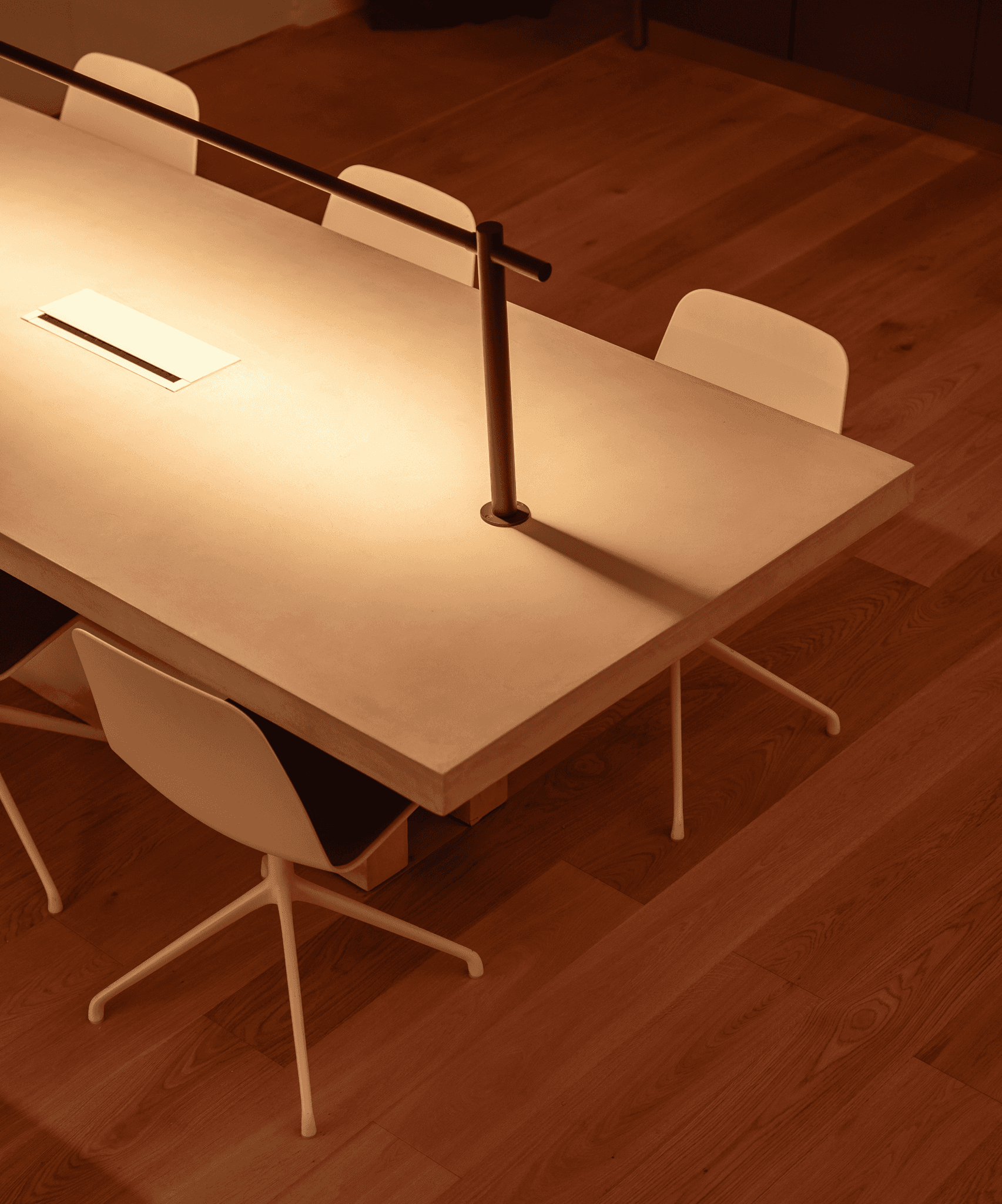 Astrophat Studio workspace — warm minimalist office interior with custom lighting and crafted furniture, showcasing the studio’s refined aesthetic and collaborative design culture.