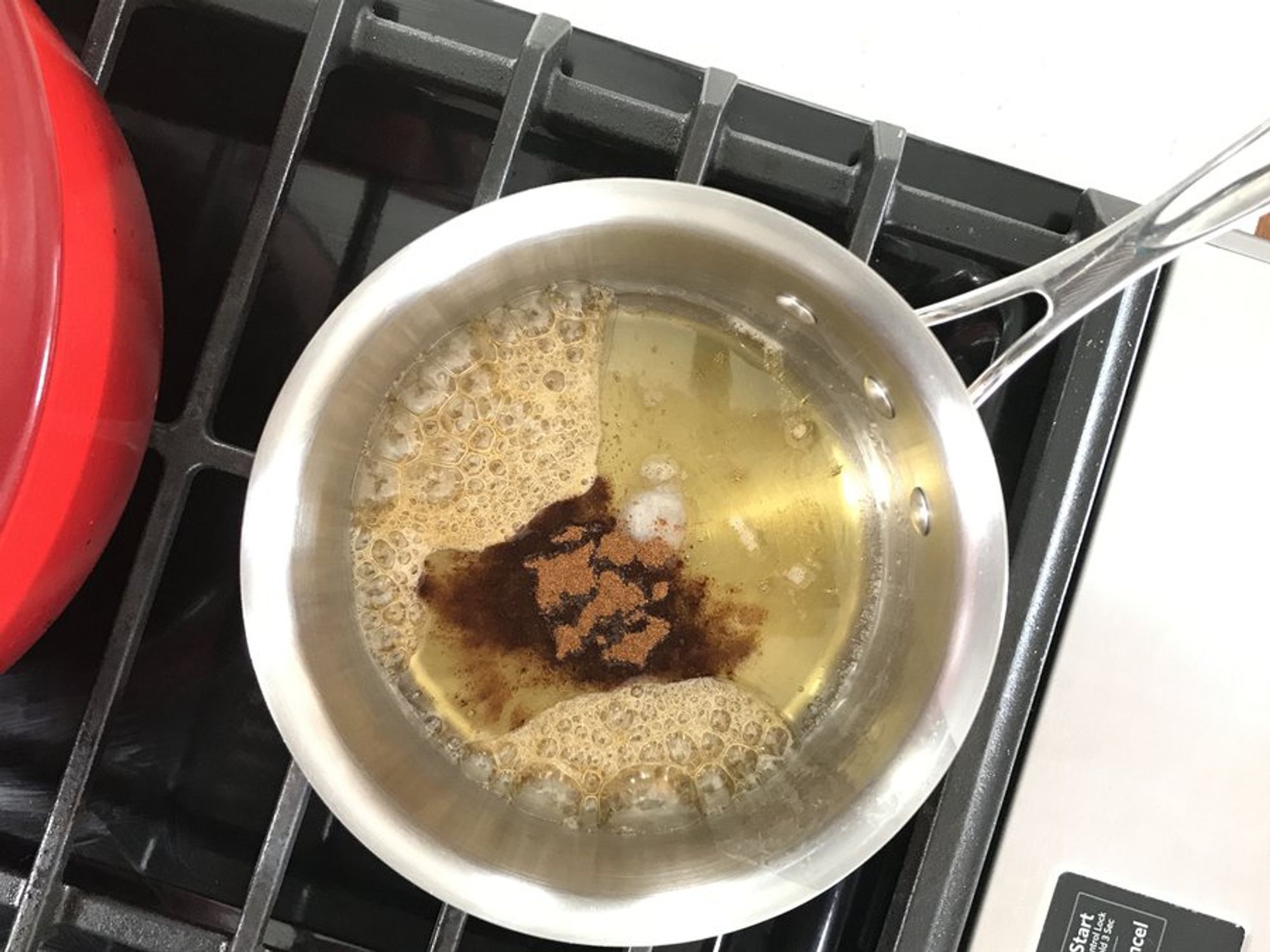 honey being melted in a small saucepan with coconut oil