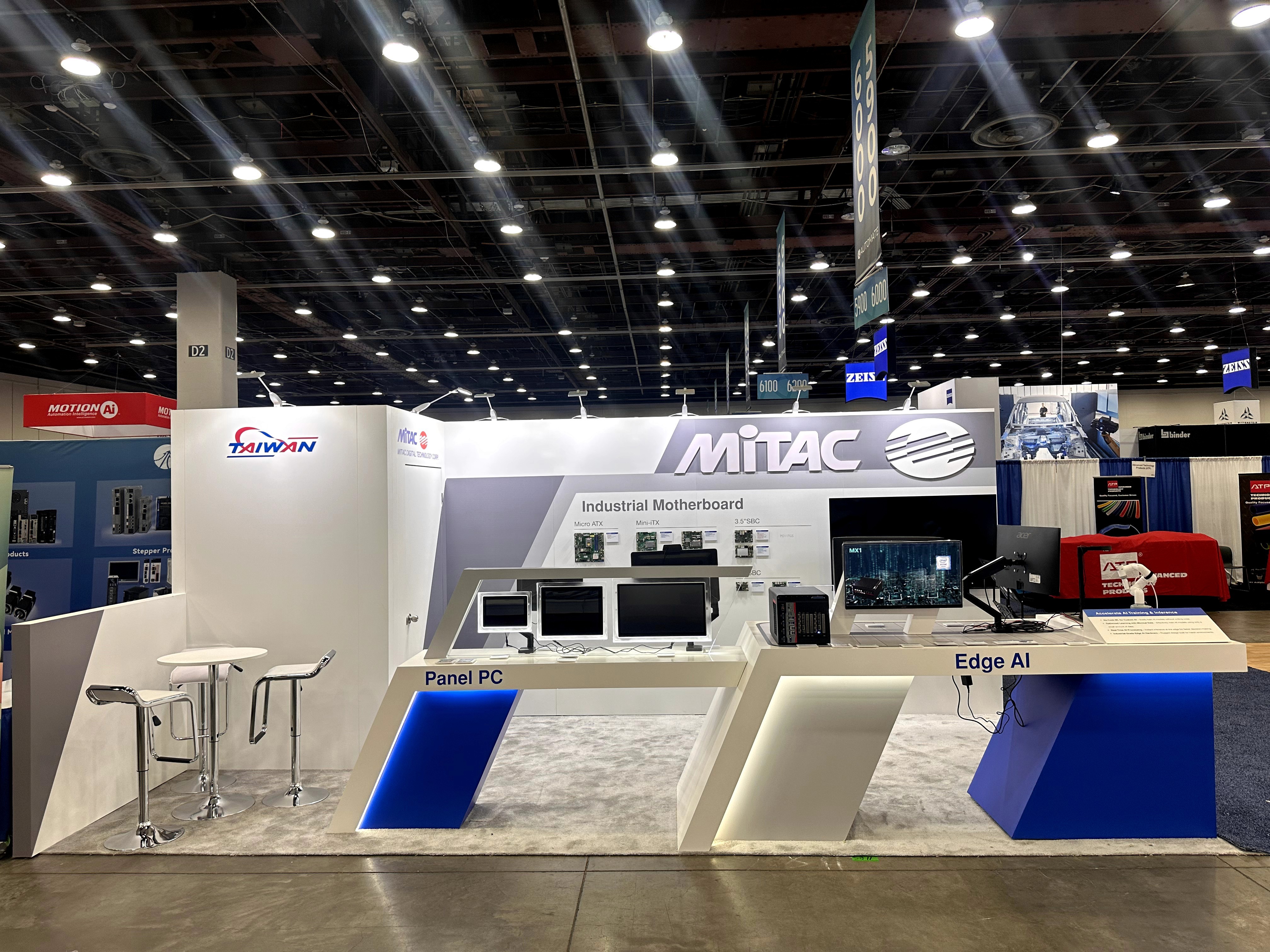 Front view of MITAC booth with Panel PC and Edge AI demo counters and large brand header at Automate 2025