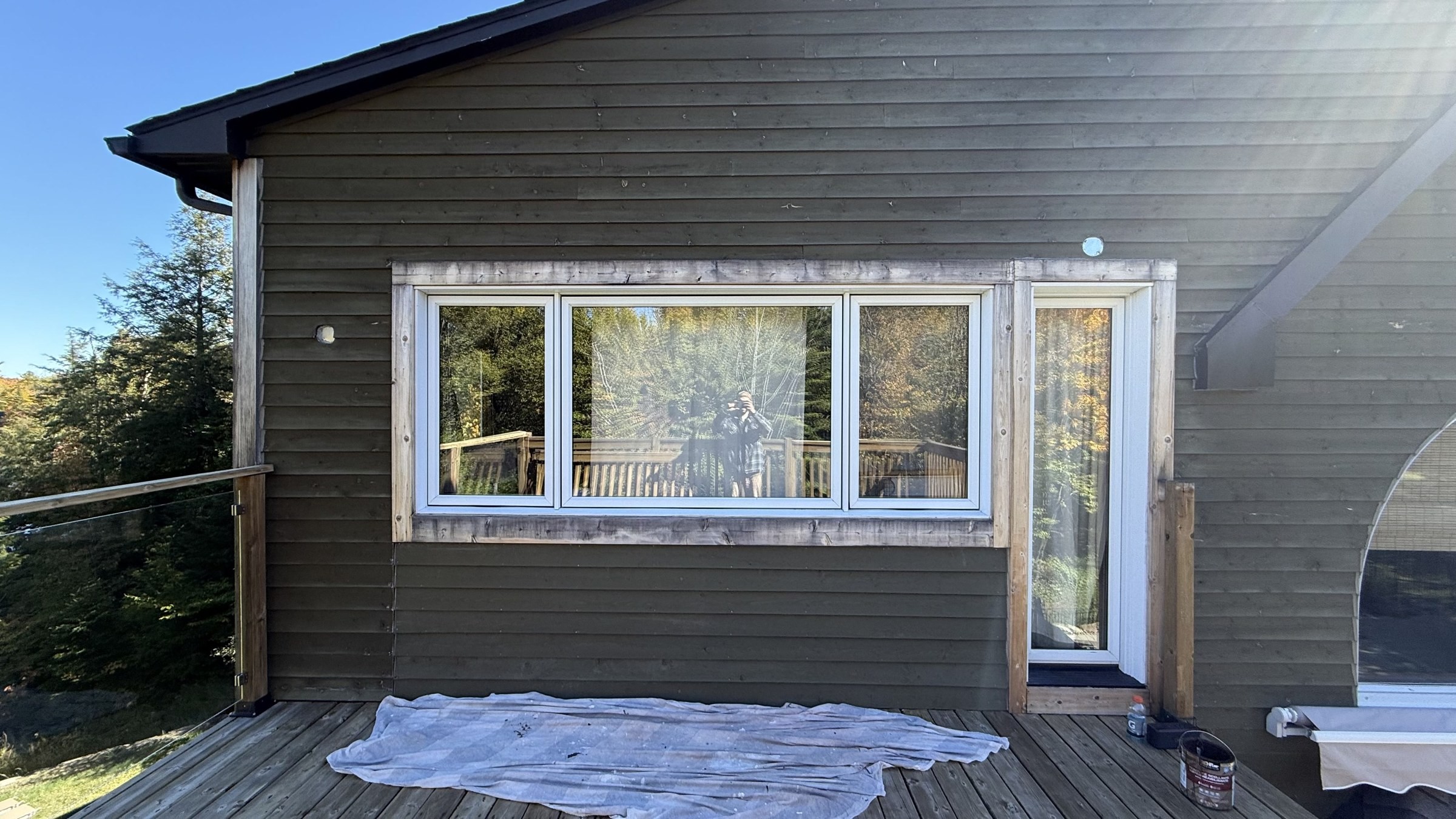 Chalet exterior with window frames prepped for repainting