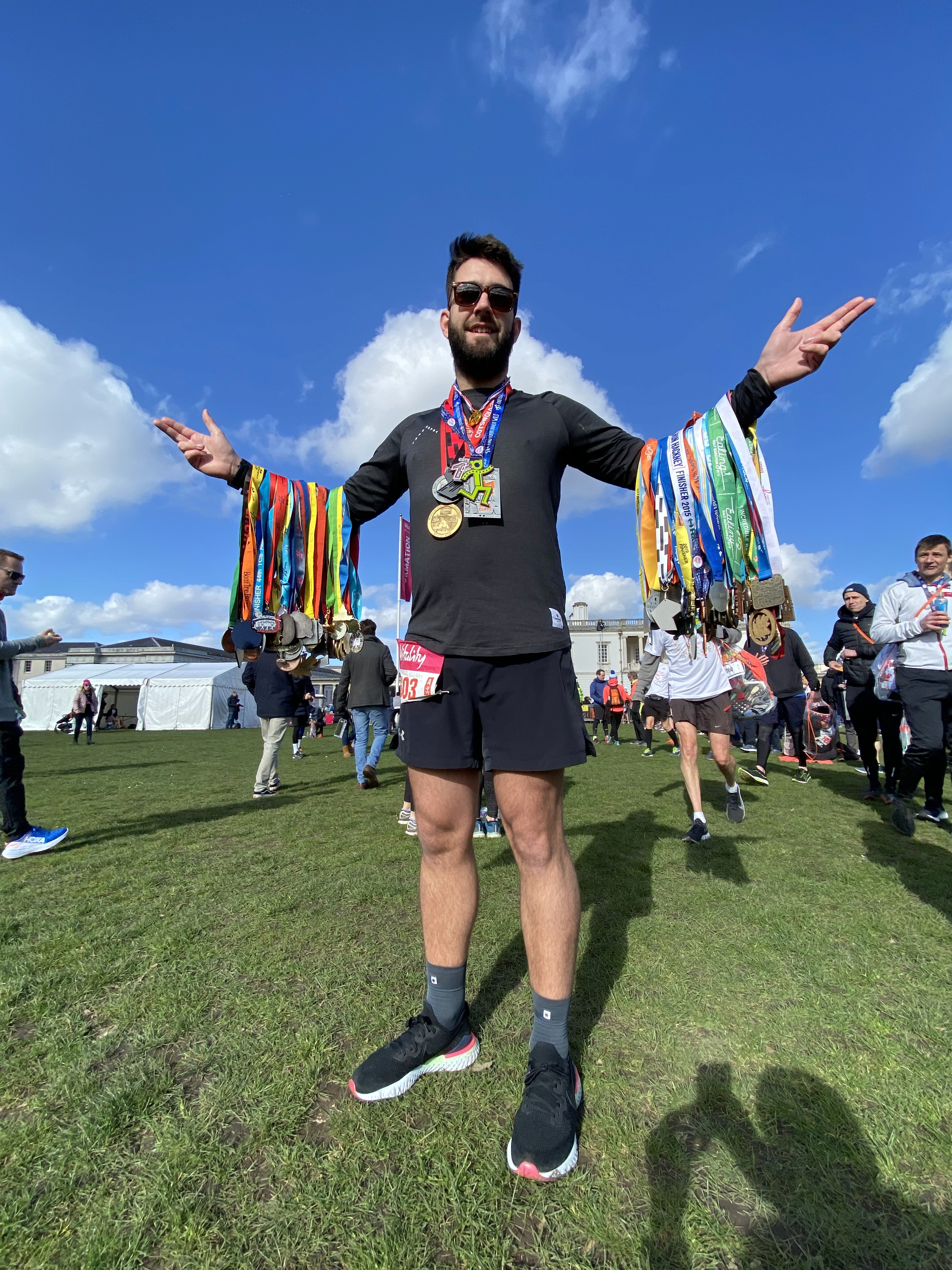 Ben Hubbard holding 100 medals