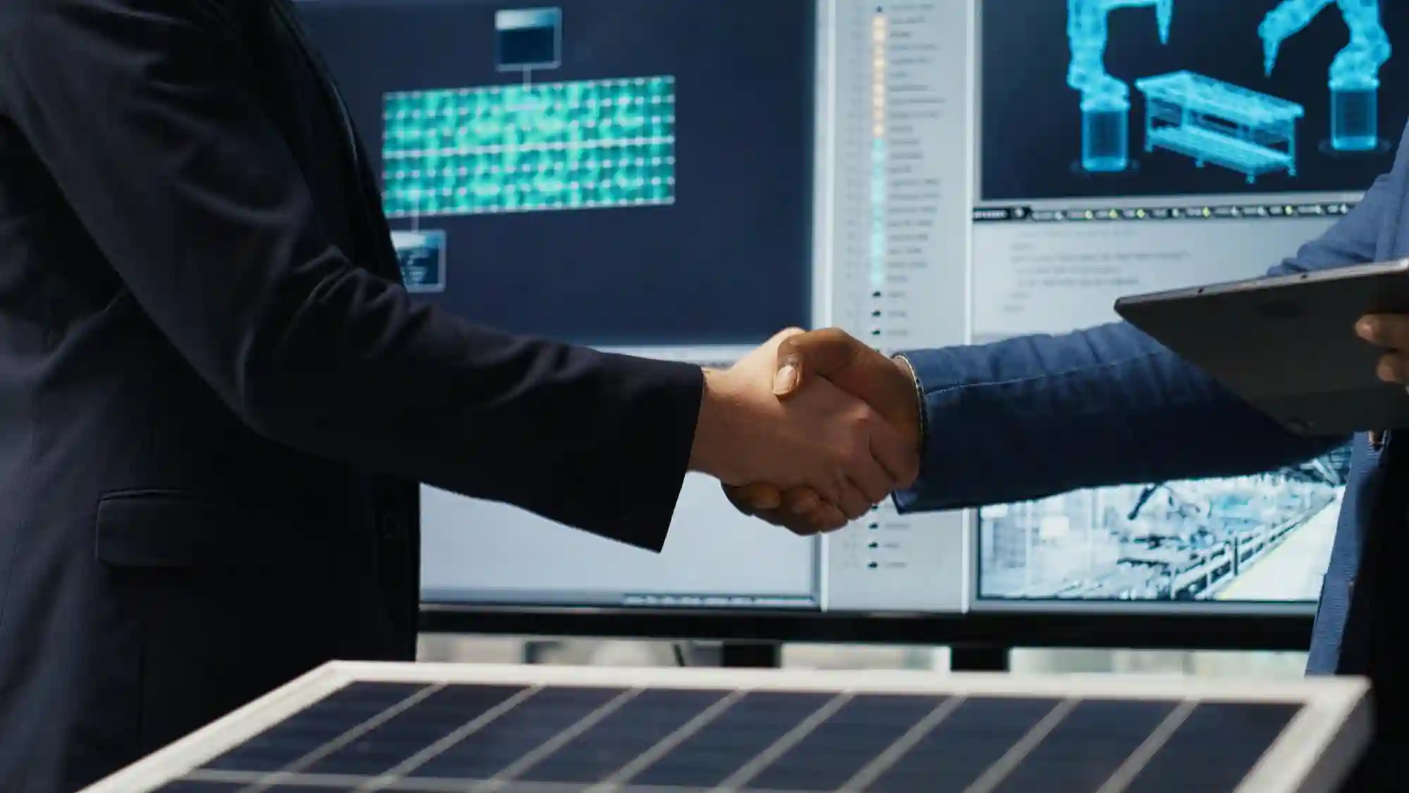 Professional handshake in a high-tech control room featuring solar panels and digital displays representing a renewable energy partnership.
