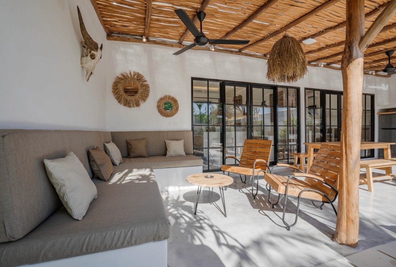 Chic terrace lounge with rustic decor. Our real estate agency offers the best properties near Nyanyi Beach, Bali.
