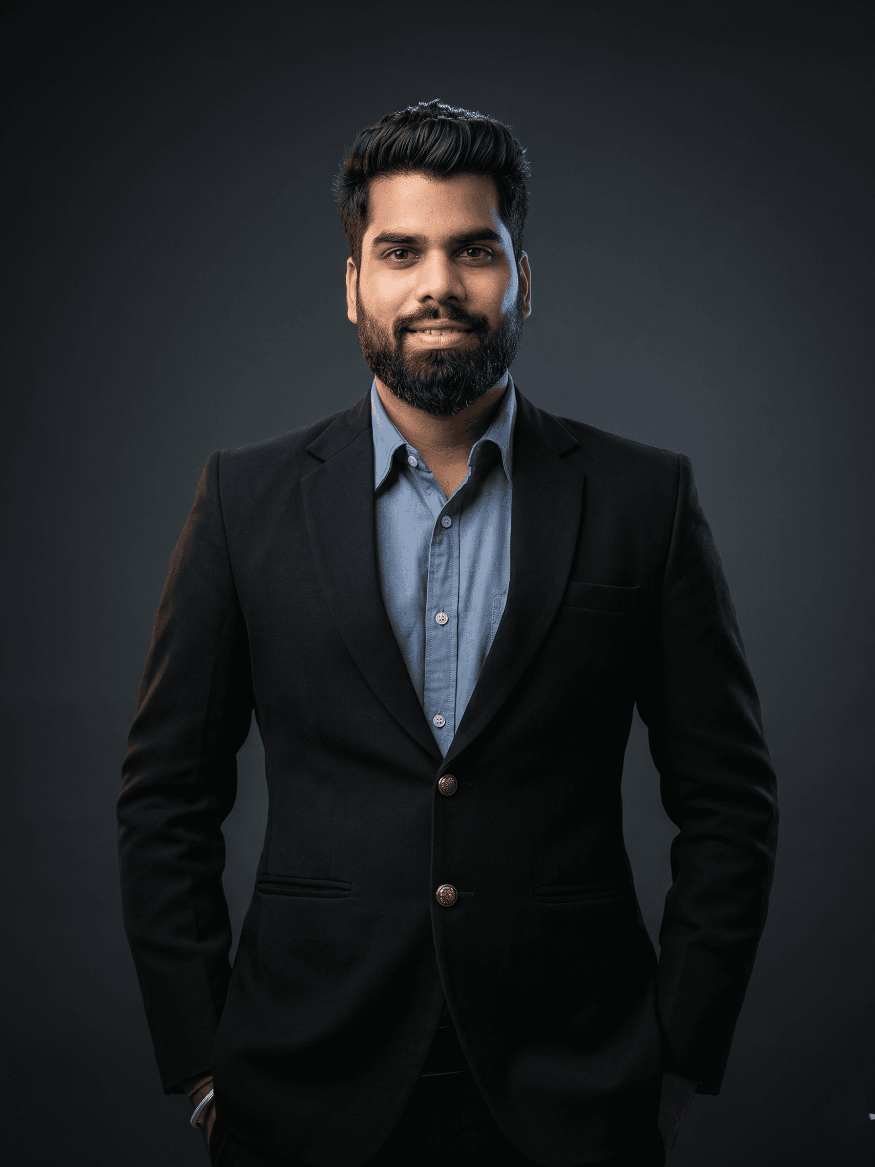 Professional portrait of Rankawat Group Jaipur team member in formal black suit and white shirt, confident corporate profile headshot for real estate company website.