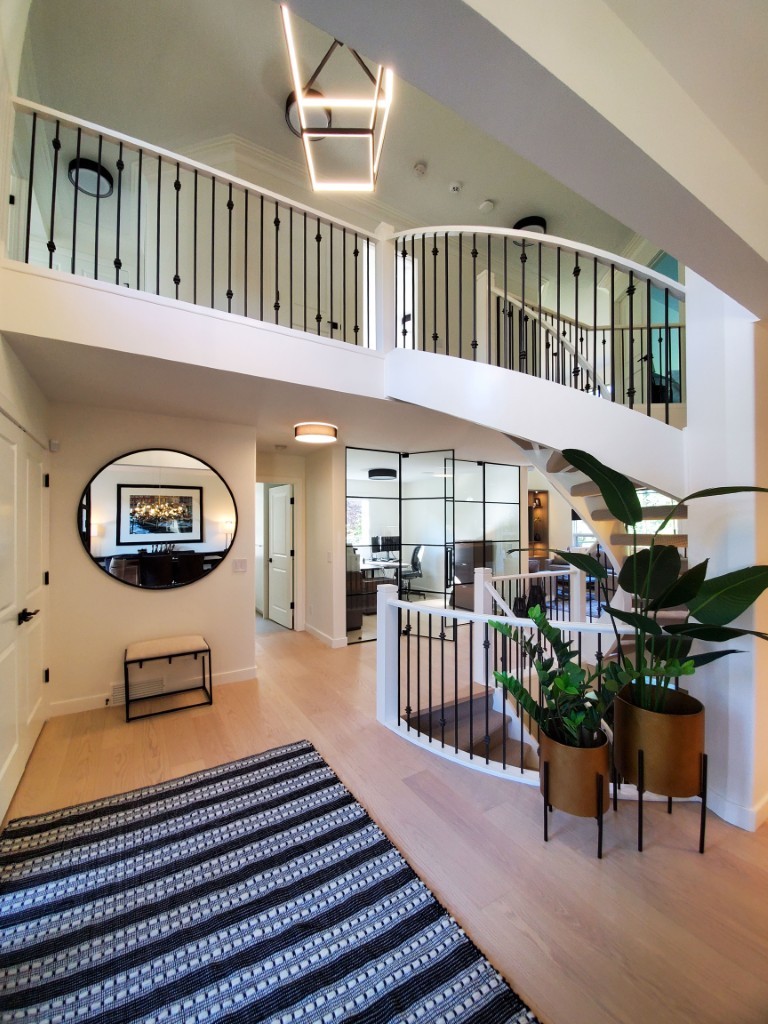 Image of KHD Homes interior design featuring a spacious open layout with staircase and modern home decor elements.
