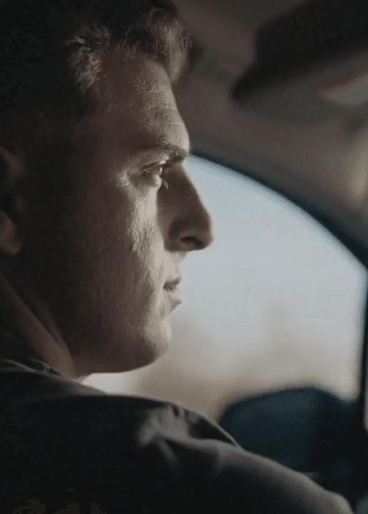 A young man surfing on the Malibu coastline.