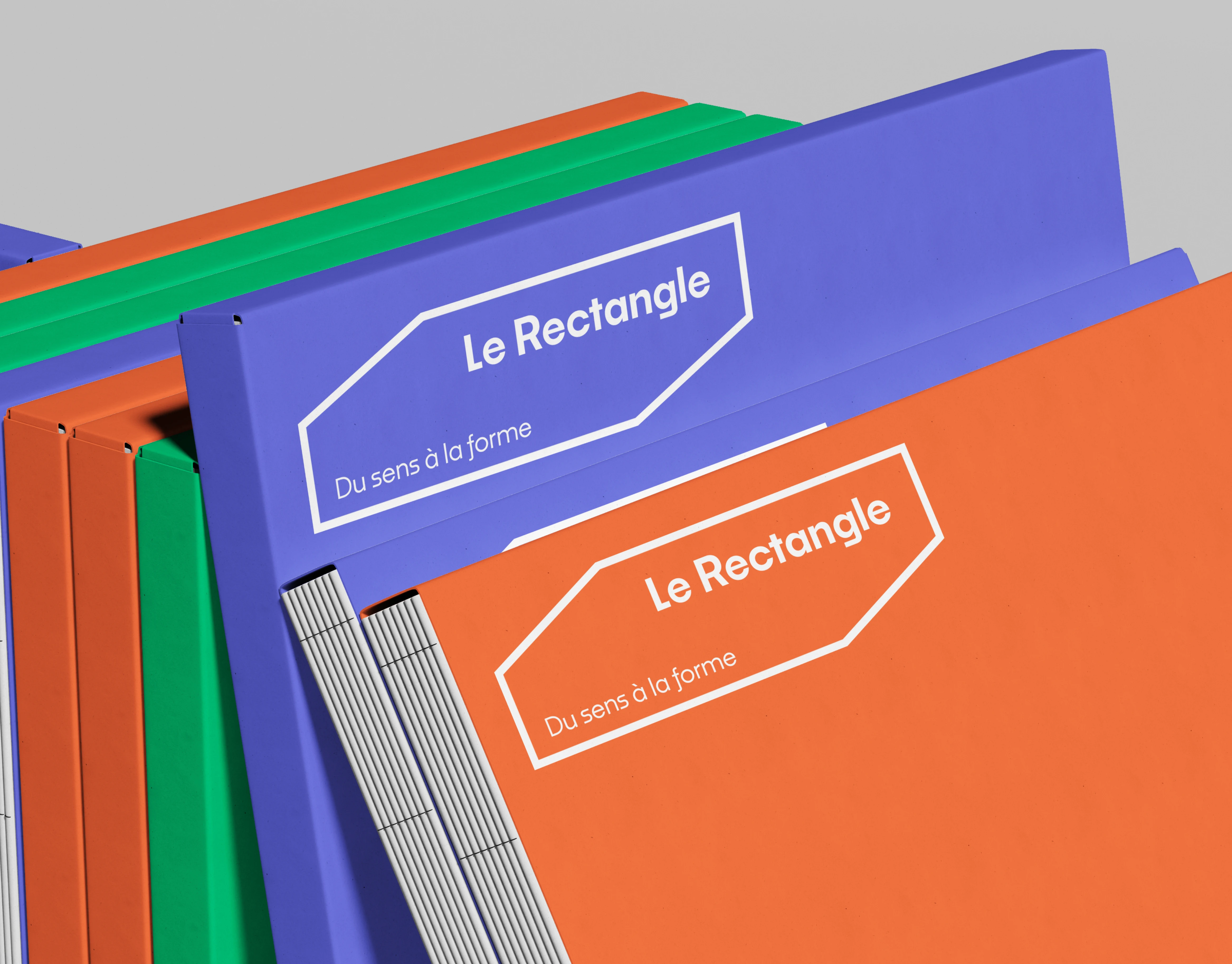 Mockup classeurs Le Rectangle déclinés dans les trois couleurs de la palette — bleu, vert, orange avec logo blanc, application du système graphique modulaire, Tartelette Concept graphiste Toulouse
