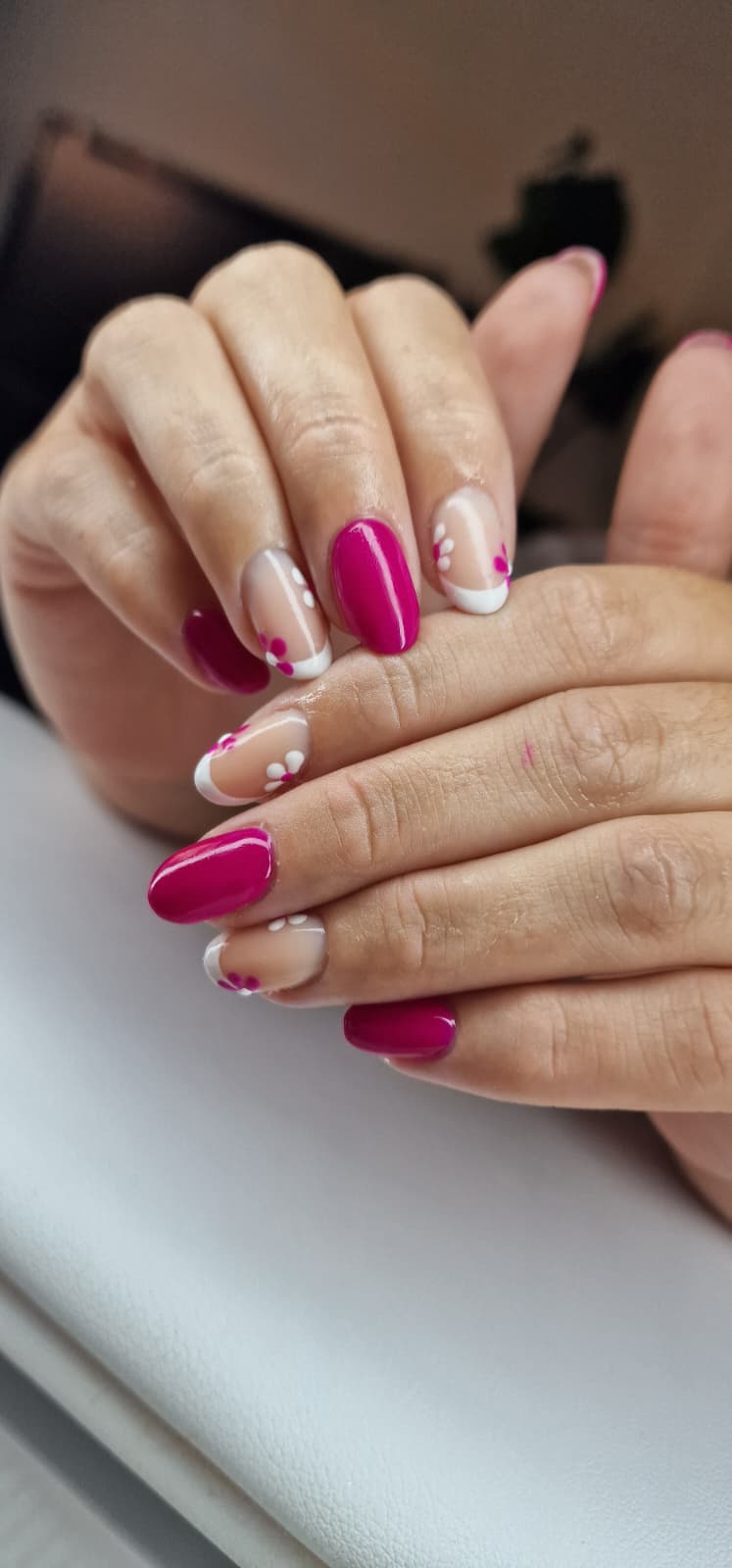Hand with nude and glittery rhinestone nails in a sweater
