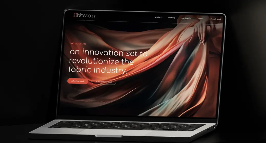 Blossom Website Design case study: Modern and innovative web design for the fabric industry displayed on a laptop screen.