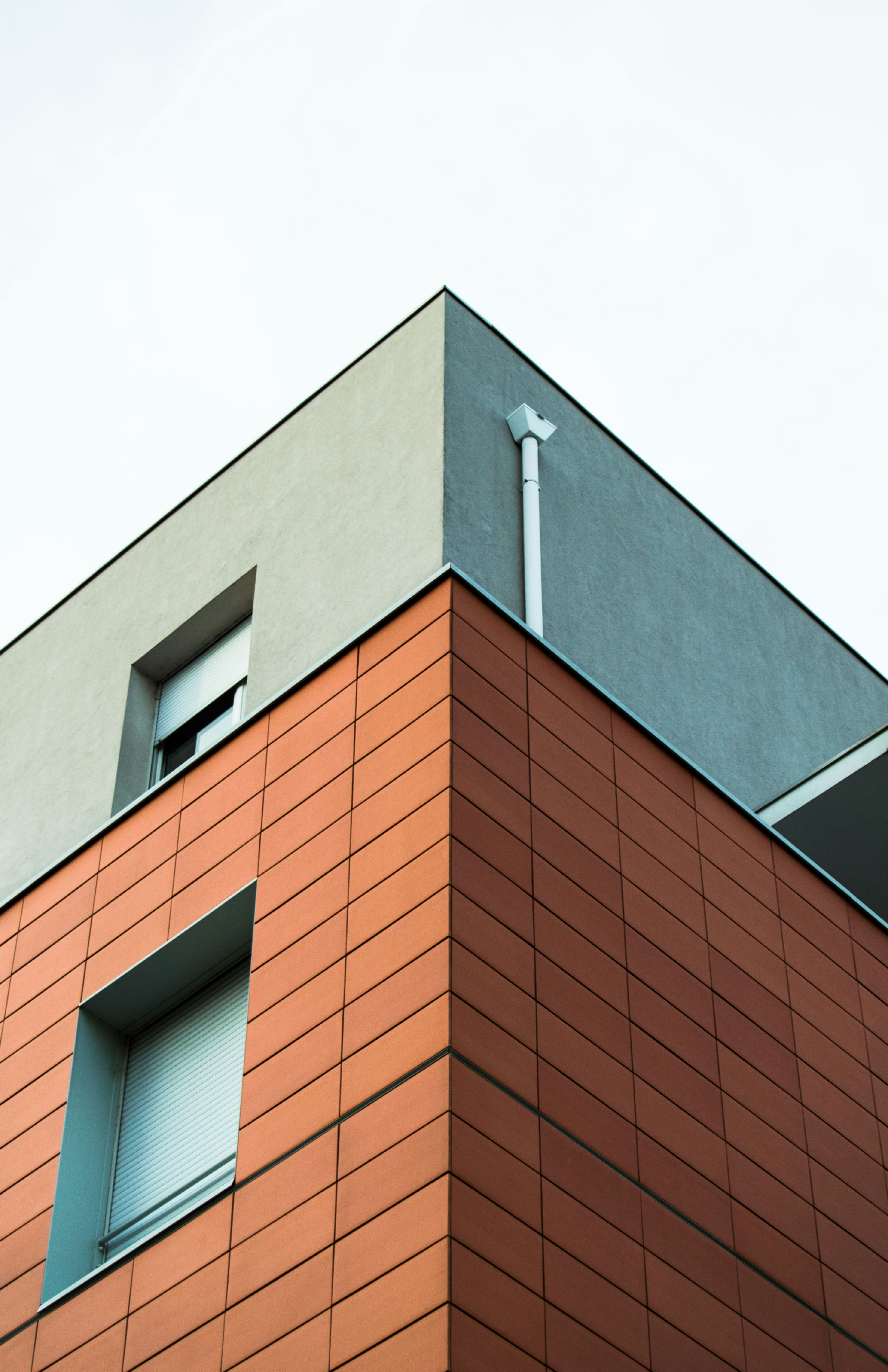 A tall orange building with a sky background