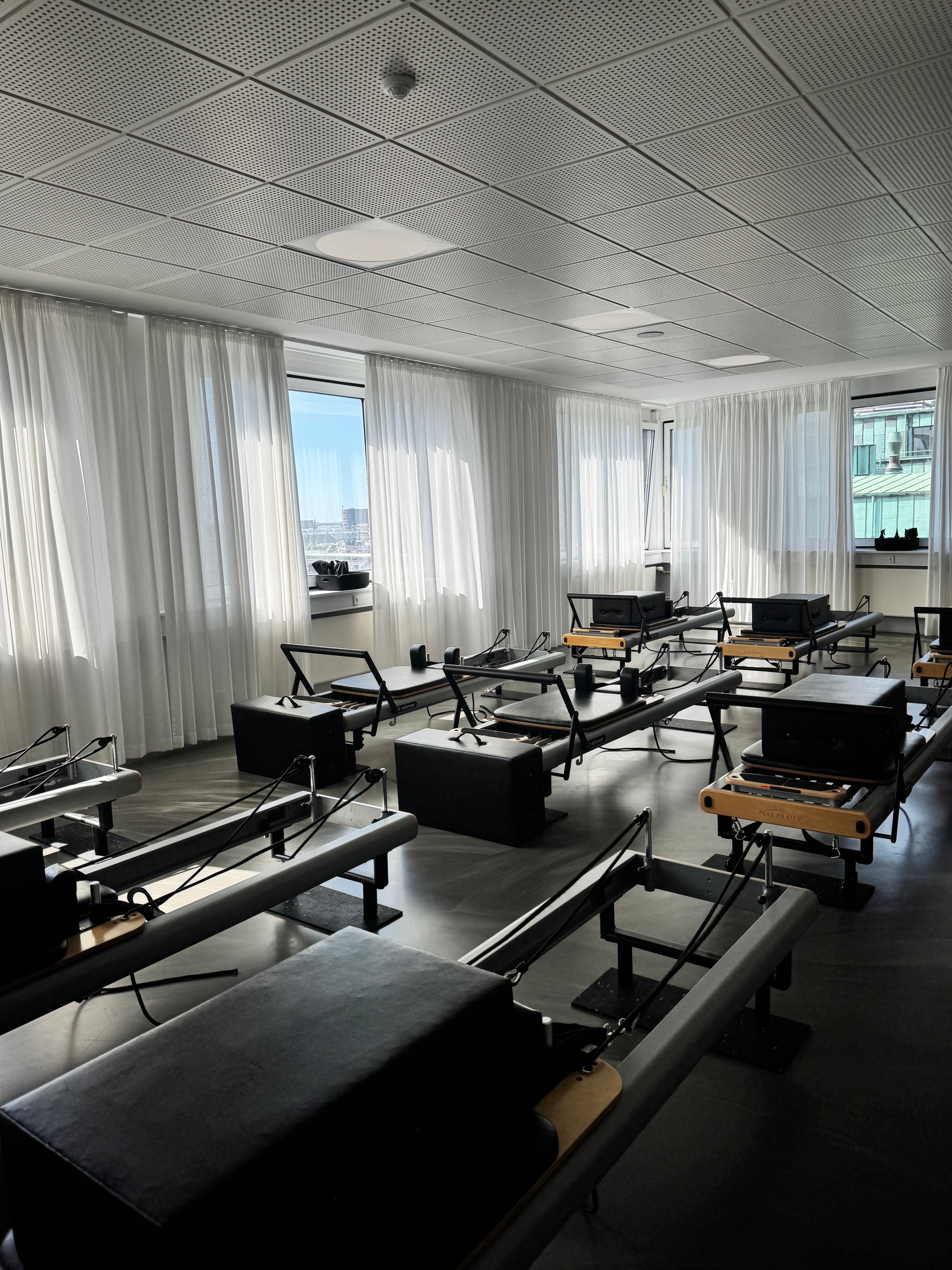 Pilates reformer session in a warm-toned studio