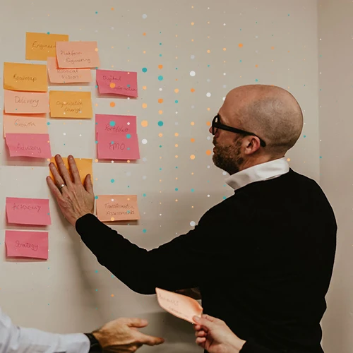 person looking at sticky notes