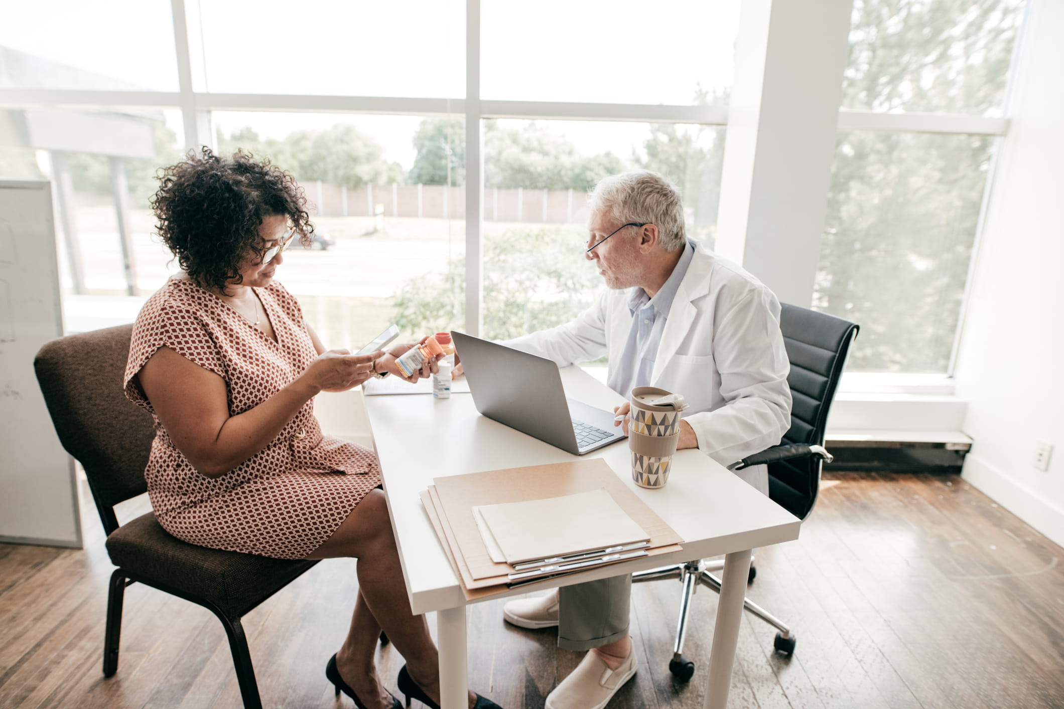 Doctor discussing prescription medication options with a patient during a healthcare consultation