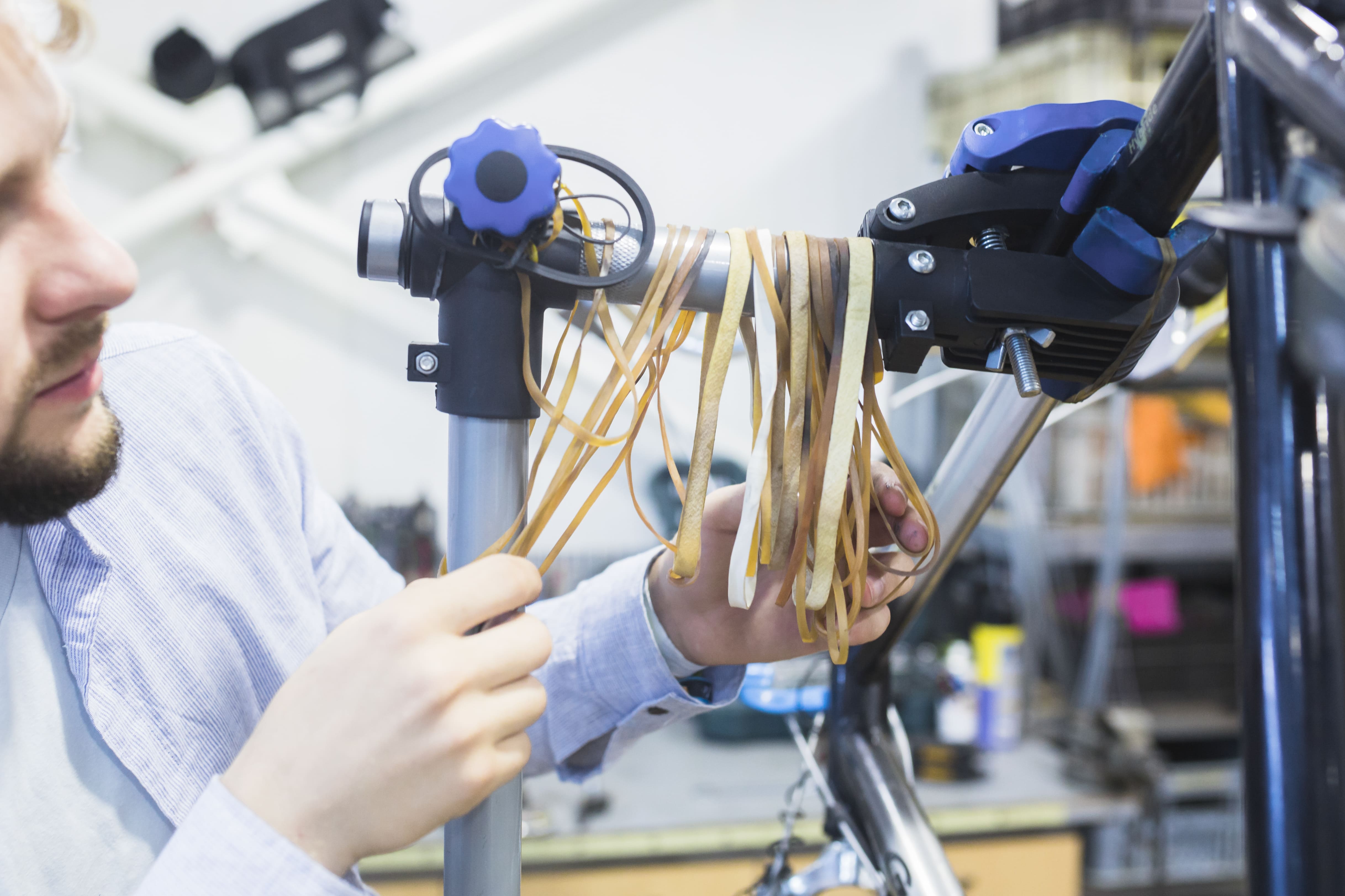 Aerial view of a winding road cutting through rocky terrain with patches of grass.