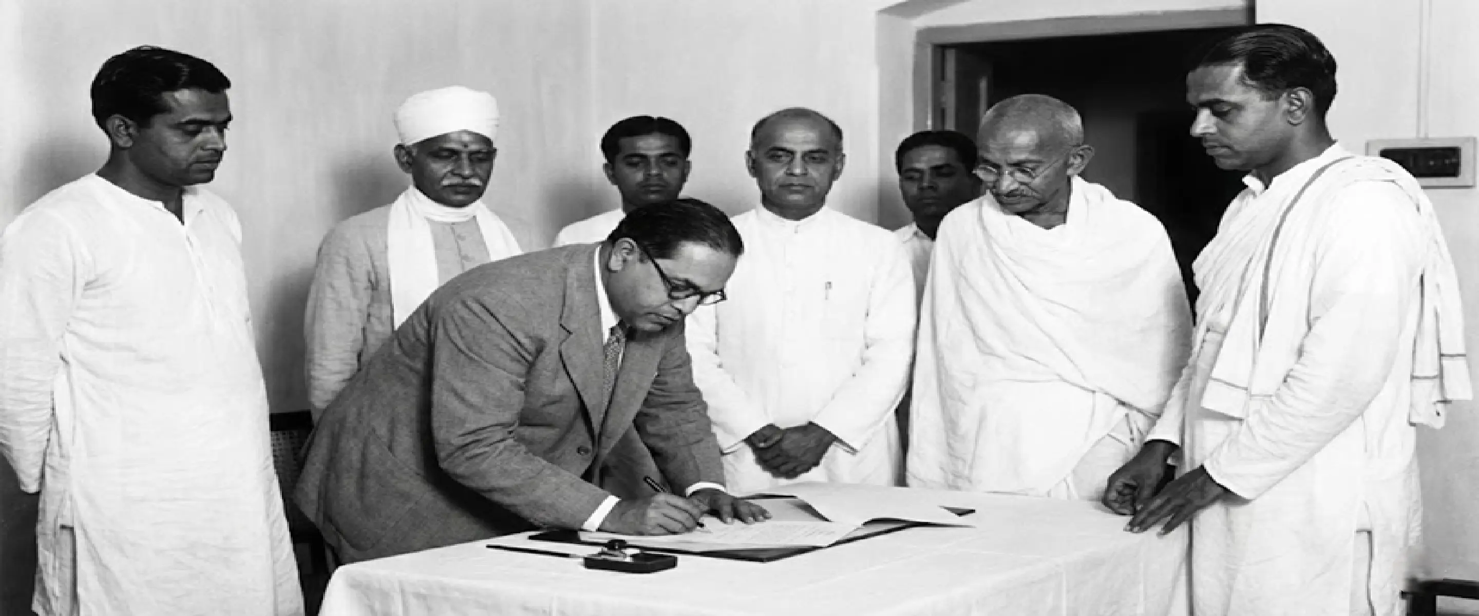 Dr B.R. Ambedkar signing the Poona Pact